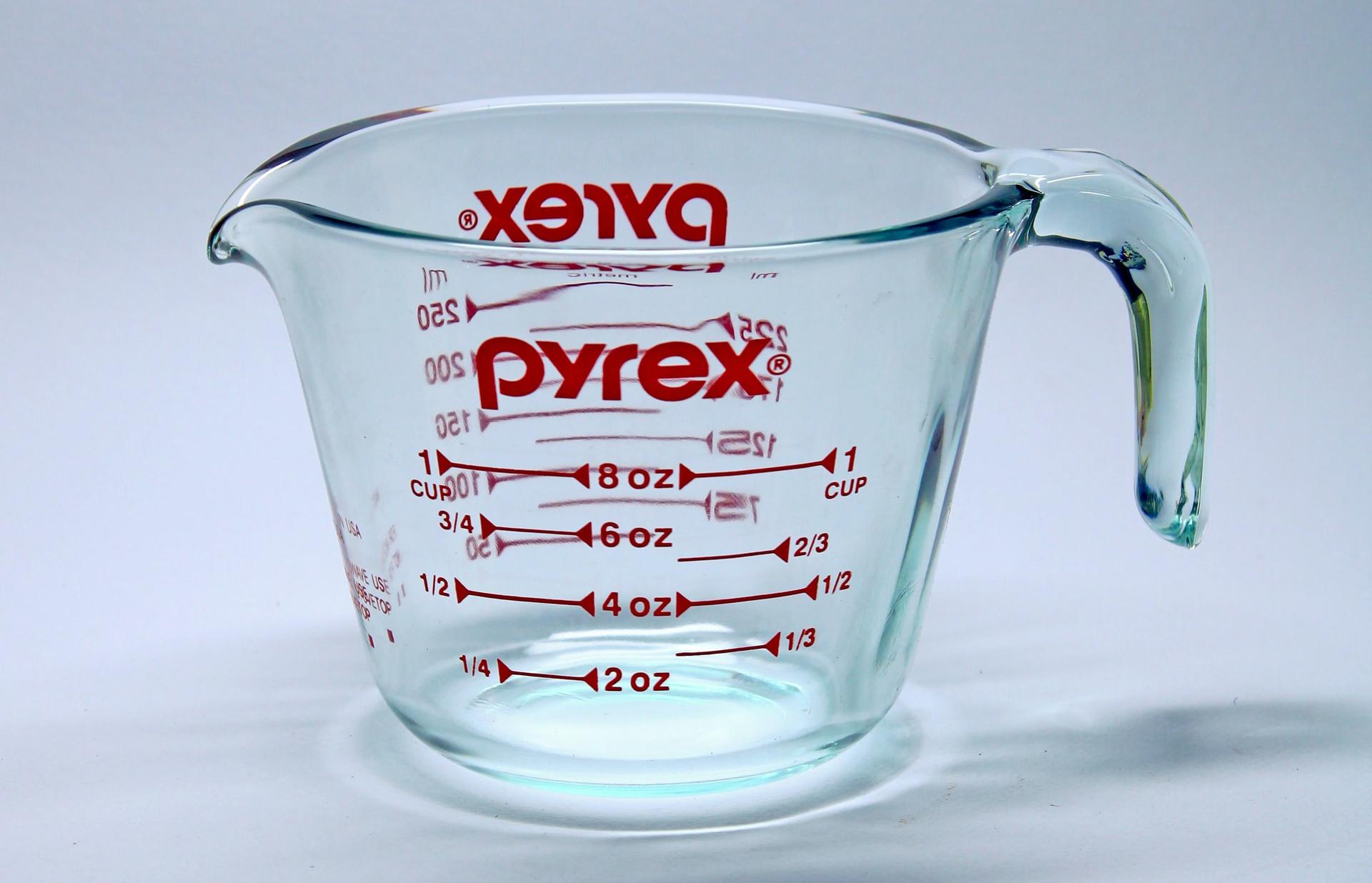 clear glass measuring cup on white surface